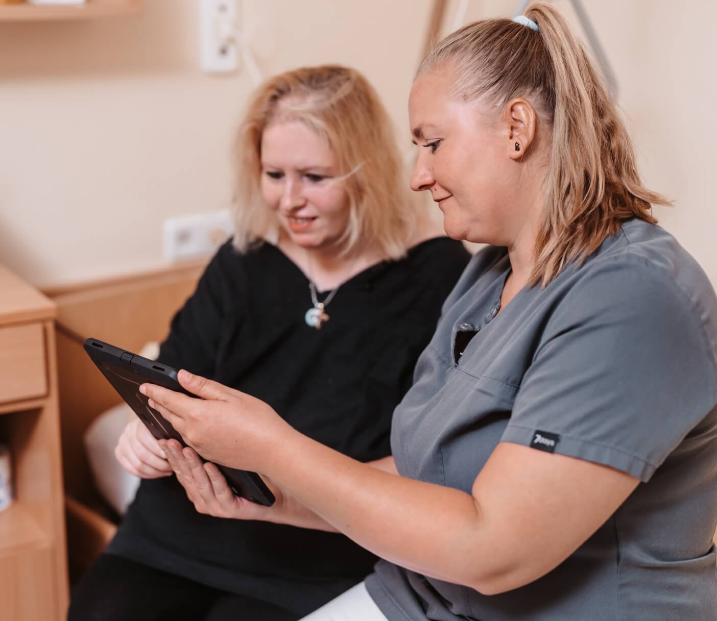 Pflegekraft nutzt Tablet mit automatischer Speicherung und Synchronisation